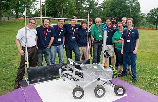 The West Virginia University Mountaineers pose with their robot, Cataglyphis, and officials at the 2014 NASA Centennial Challenges Sample Return Robot Challenge at Worcester Polytechnic Institute in Worcester, Mass., after completing Level 1 for a prize of $5,000. A year later, the team won the $100,000 Level-2 Prize. In 2016, Team Mountaineers won the final challenge with a $750,000 prize (NASA/Joel Kowsky)