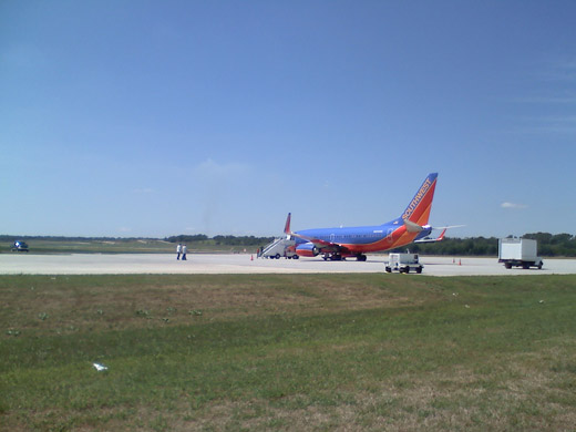 
A Southwest Airlines 737-700 with a military charter on the apron.