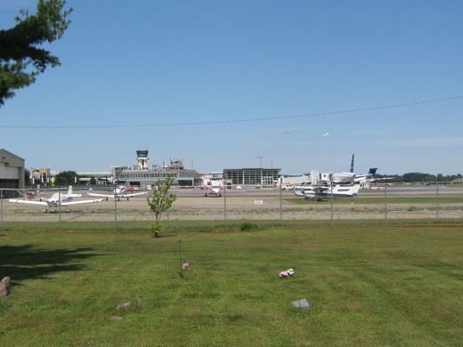 
A general aviation ramp at BTV with the passenger terminal and tower in background