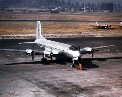 
A Douglas C-74 Globemaster I at Long Beach Airport with Boeing B-17 and C-46 Curtiss Commando aircraft in the background.