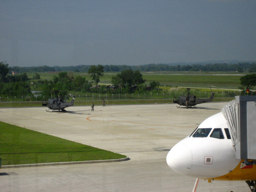 
A Cebu Pacific aircraft and two military helicopters parked at the Iloilo International Airport apron