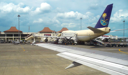 
On the apron, Saudi Airlines Boeing 747 refueling and reloading to serve Indonesian Hajj pilgrims to Mecca.