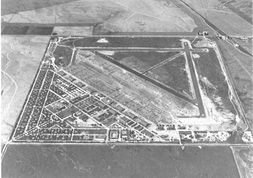 
Oblique aerial photo of March Field in May 1940, just before World War II, looking north to south. Hard surfaced runways have been constructed and the containment area has many new buildings.