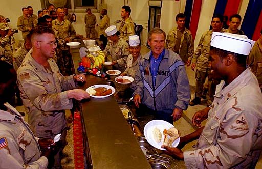 
U.S. President George W. Bush with troops at the Bob Hope Dining Facility on Thanksgiving 2003.