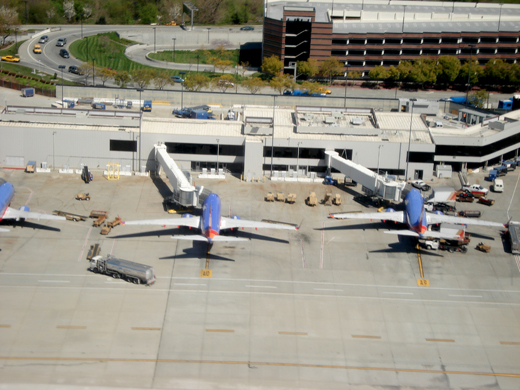
Southwest Airlines Boeing 737 aircraft parked at Terminal A with parking structure behind