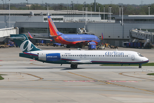 
An AirTran Airways Boeing 717-200 with a Southwest Airlines Boeing 737-700 in the background.