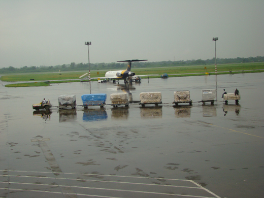 
A GMG airlines aircraft waits at the runway on a rainy day.