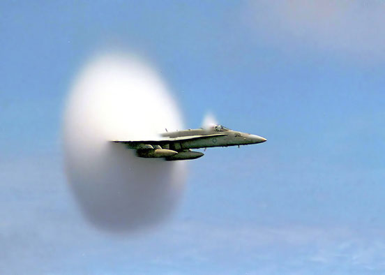 
U.S. Navy F/A-18 breaking the sound barrier. The white halo is formed by condensed water droplets which are thought to result from a drop in air pressure around the aircraft (see Prandtl-Glauert Singularity). 