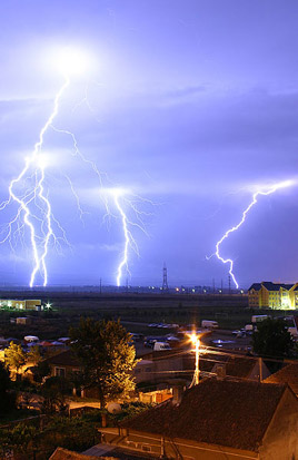 
Lightning is an example of plasma present at Earth's surface. Typically, lightning discharges 30,000 amperes, at up to 100 million volts, and emits light, radio waves, x-rays and even gamma rays. Plasma temperatures in lightning can approach ~28,000 Kelvin (~27,700°C) and electron densities may exceed 10/m³.