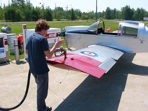 
An American Aviation AA-1 Yankee showing its wing trailing edge with aileron (deployed downwards) and flap while being refuelled