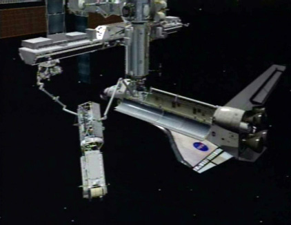 
3D computer rendering of the CANADARM on Atlantis handing the P3/P4 Truss segment to the Canadarm2 on the International Space Station during STS-115.