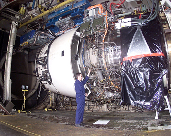 
Mechanic working on a Rolls Royce Trent 900 engine during testing. The Trent is a typical type of high bypass turbofan used in wide-body airliners.