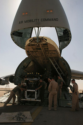 
The forward section of the C-5 Galaxy lifts open to allow loading of bulky items, such as this load of 3 CH-46 helicopters.