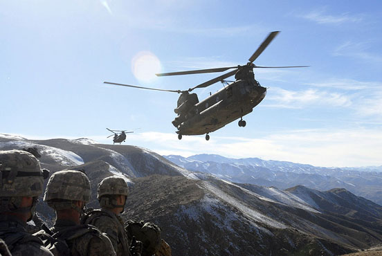 
Soldiers wait for pickup from two Chinooks in Afghanistan, 2008.