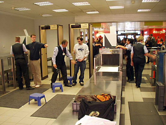 
Baggage is scanned using X-ray machines, passengers walk through metal detectors