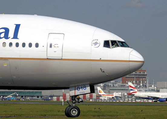 
A pilot can be seen on the flight deck of this Continental Airlines Boeing 777-200 as it taxis to the take off point at London Heathrow Airport, England.