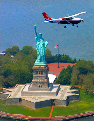 
A Civil Air Patrol Cessna 182 Skylane flies over the Statue of Liberty after the attacks of September 11, 2001