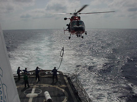 
Raising a hose from ship to an HH-65