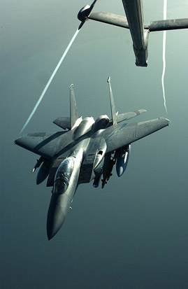 
An F-15E Strike Eagle disengages from a KC-10 Extender, using a boom with an He 162 style of control surface