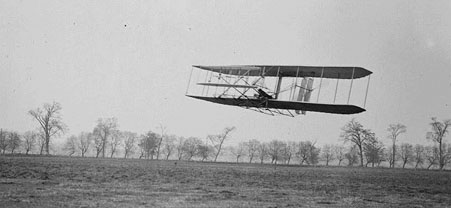 
Orville in flight over Huffman Prairie in Wright Flyer II. Flight #85, approximately 1,760 feet (536 m) in 40 1/5 seconds, November 16, 1904.