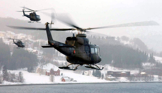 
A group of Norwegian Bell 412 helicopters take part in a military exercise.