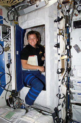 
Astronaut Peggy Whitson in the doorway of a sleeping rack in the Destiny laboratory