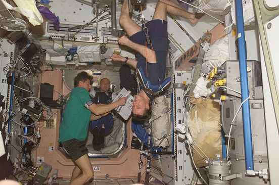 
Astronauts on the ISS in weightless conditions. Michael Foale can be seen exercising in the foreground.