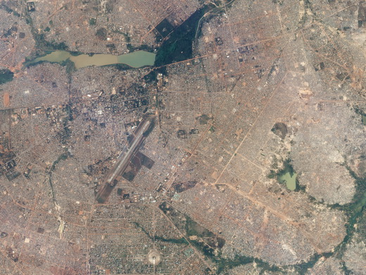 Aerial photograph of Ouagadougou with airport runway visible at centre