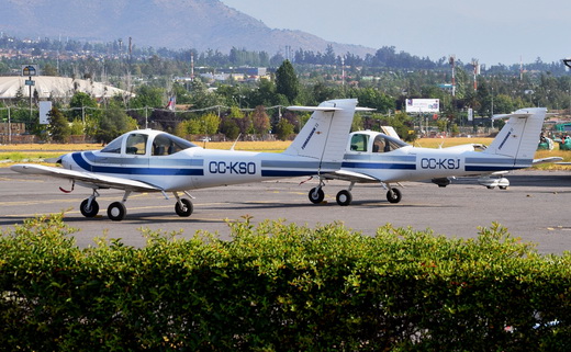 Two Piper PA-38 Tomahawks sitting at one of many parking spots at Tobalaba Airport.