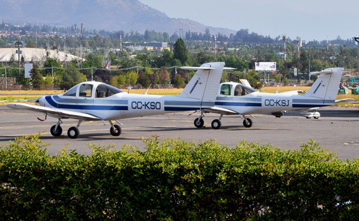 Two Piper PA-38 Tomahawks sitting at one of many parking spots at Tobalaba Airport.
