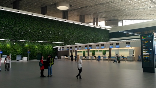Check-in desks and wall with natural plants