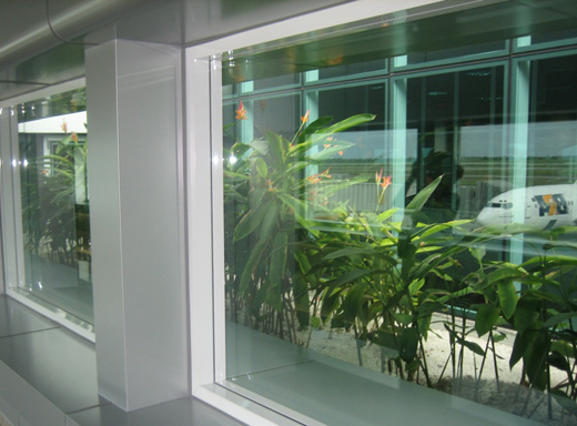
View from passenger lounge through plantings to inter-gate concourse and aircraft ramps. Photographed 2007.