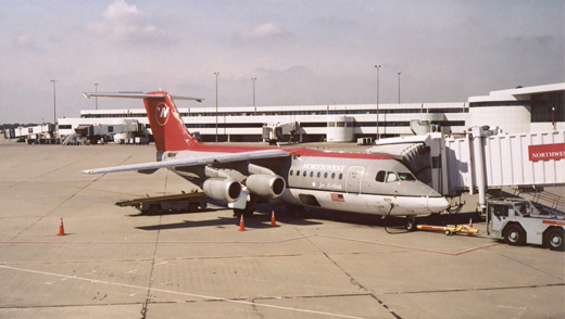 
Northwest Airlink Avro Regional Jet at Gate B3 in September 2005, with Concourse A in the background. Northwest later retired this type of aircraft.