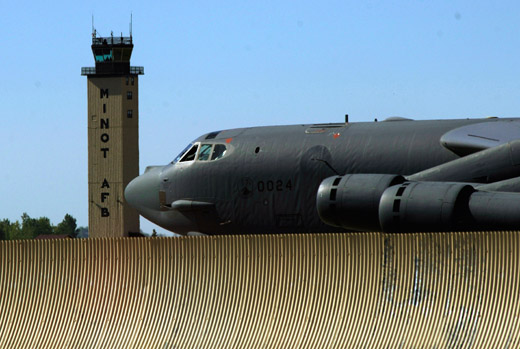 
A B-52H with the 5th Bomb Wing taxis past the Minot AFB control tower