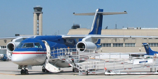 
A Midwest Express Dornier 328JET on the tarmac in front of the airport's 200-foot-high (61 m) control tower
