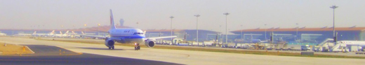 
Terminal 3-E and 3D seen from airfield, with an Air China aircraft taxiing