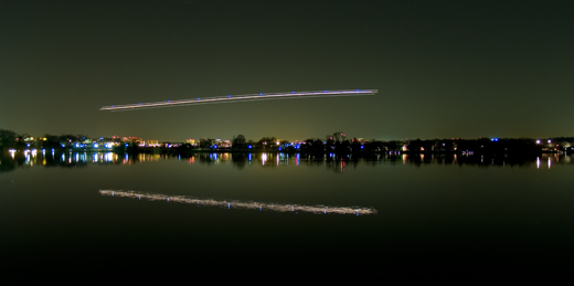 
A plane descending over the Potomac River at night, making its final approach to the airport.