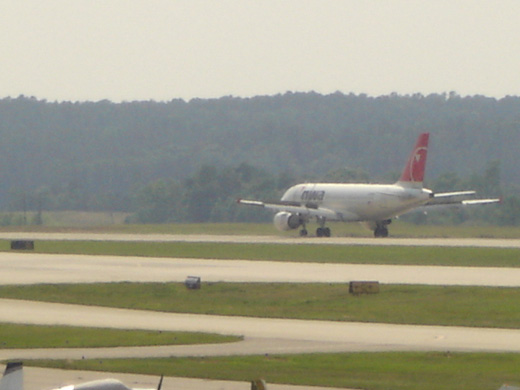 
A Northwest Airlines aircraft landing on Runway 5L-23R.