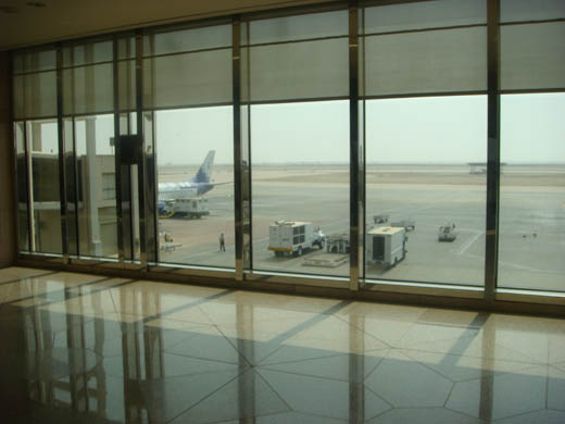 
A Sama Airlines B737 parked at the airport, bound for Medina. View from the departure lounge of the terminal.