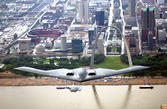B-2 in flight over the Mississippi River (St. Louis, Missouri) with the Gateway Arch and Busch Stadium in the background