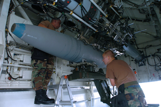 A 2,000 lb (910 kg) BDU-56 bomb being loaded onto a bomb bay's rotary launcher, 2004
