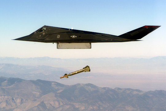 An F-117 conducts a live exercise bombing run using GBU-27 laser-guided bombs