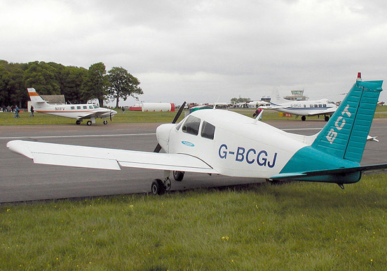 
Ailerons are the trailing-edge control surface nearest the wing tip (although on some airliners they can also be found at the wing root). On this parked Piper Cherokee, the left aileron has deflected downwards, and the right, upwards.