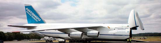 
An-124-100 kneeling with front ramp down (note tilt of aircraft fuselage and retraction of front wheels)