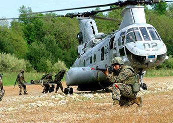 
Marines load a simulated casualty onto a CH-46E while conducting convoy operations training at Camp Dawson, West Virginia.