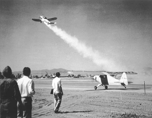 Take-off of America's first rocket-assisted fixed-wing aircraft, an Ercoupe fitted with a GALCIT developed solid propellent JATO booster with a thrust of 28 pounds force (125 N). The Ercoupe took off from March Field, California and was piloted by Captain Homer A. Boushey Jr.