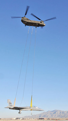 
A CH-47 lifts an F-15 to a training installation at Creech Air Force Base
