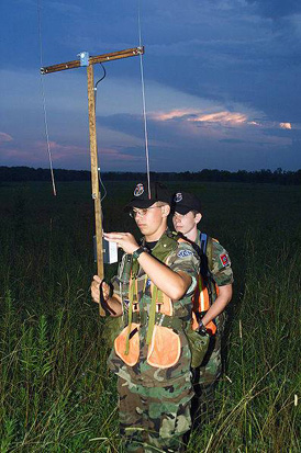 
Civil Air Patrol members practice searching for an emergency locator transmitter. The member in front is using a manual radio direction finder.