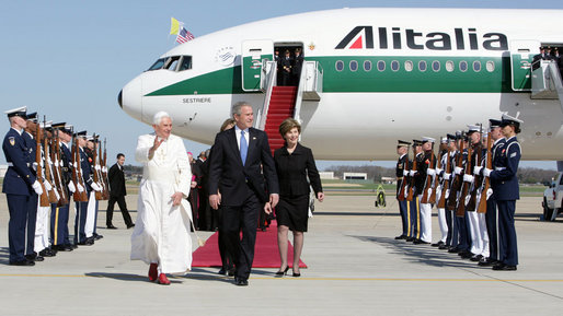 
President George W. Bush walks the red carpet with Pope Benedict XVI. Behind is 