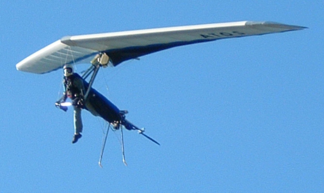 
Pilot semi-upright with one leg in the harness' boot for stability during final approach.